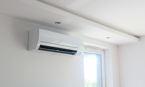 a split air system air conditioner mounted to a wall