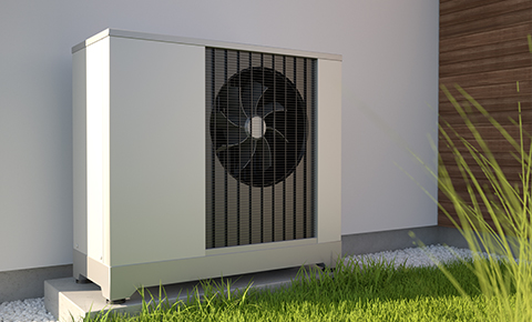 an external air flow heat pump on the outside of a building