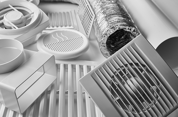 the components of an air ventilation system on a white table. 
