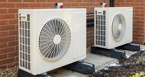 two air source heat pumps installed outside of a property